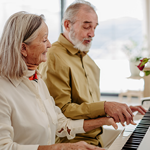 AL-Senior couple playing on piano together at home-300w AL-Senior couple playing on piano together at home-300w
